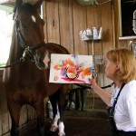 Mary Simons of ReRun Thoroughbred charity asked Jamaica and his teammate Rolex to help raise money for charity by painting masterpieces known as “Moneighs.”  (Photo courtesy of ReRun, Inc)