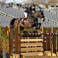 Megan Edrick and Cadence sailing over an oxer in the Olympic Stadium at the Georgia International Horse Park. Flashpoint Photography.