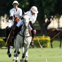 Melissa Ganzi fights off the hook going for the ball with 10-goaler Gonzalito Pieres backing her up