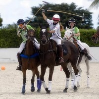 Jacqui Casey of The Polo School goes for the back shot with Mia Astrada of Grand Champions defends