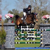 Frances Land sails over an oxer on the world class grass turf grand prix field.