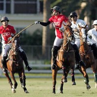 Nic Roldan of Audi tries to keep the ball in play with Audi teammate Lucas Lalor backing him up and Piaget's Brandon Phillips and Juan Bollini charging on defense