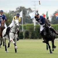 Jeff Hall of Psycho Bunny hits the ball downfield while Guille Aguero of Clearwater attempts to hook.