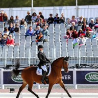 Grade II rider Rebecca Hart is all smiles aboard Schroeter's Romani in their individual test today. Photo copyright SusanJStickle.com