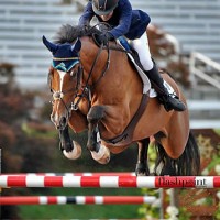 British show jumping superstar Gemma Paternoster and Figarro D sail over a jump in the Olympic Stadium